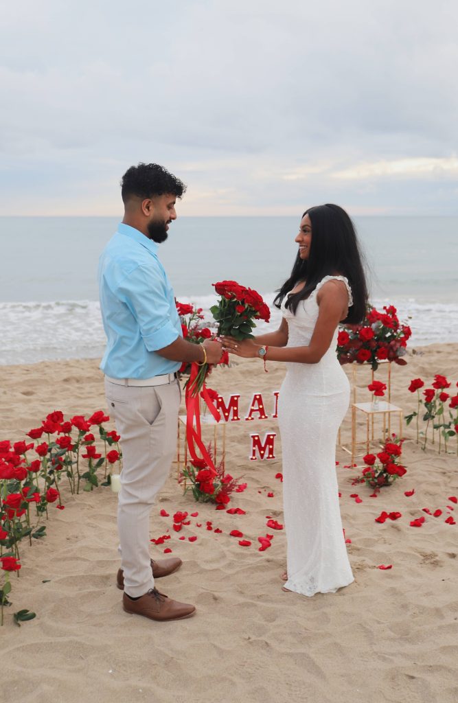 Sunset proposal Barcelona beach with romantic decoration