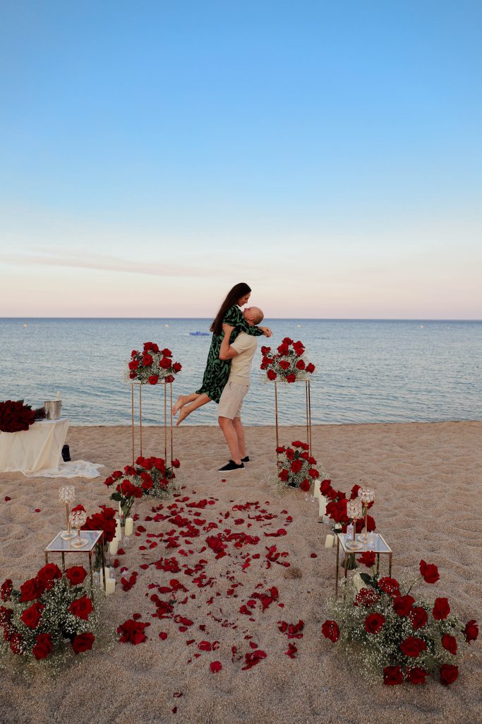 Bride-to-be discovering a romantic proposal setup on Costa Brava beach